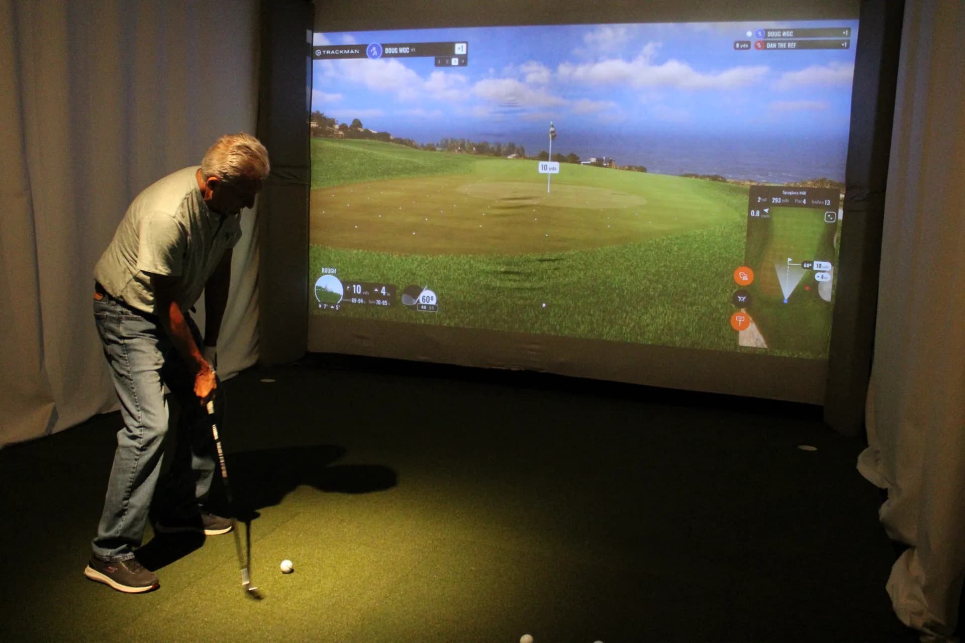 Golfer putting on a seaside course in a TrackMan simulator at Gonzo's HD Sports